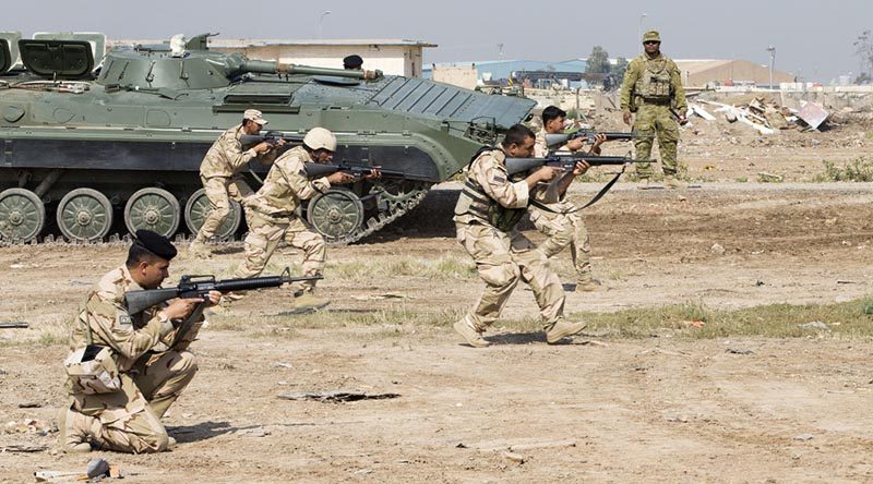 Iraqi Army soldiers conduct tactics training while Australian Army soldier Warrant Officer Class 2 Tomasi Navusolo observes, at the Taji Military Complex, Iraq. Photo by Corporal Jake Sims