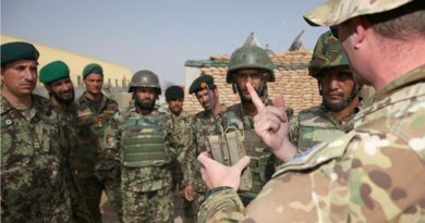 Australian Army Major Christian Van Den Bosch shows Afghan National Army soldiers from the 205 Hero Corps an Australian-made “Greengum” radio-frequency jammer that disrupts signals that trigger improvised explosive devices. Photo by Corporal Max Bree