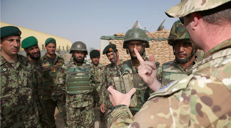 Australian Army Major Christian Van Den Bosch shows Afghan National Army soldiers from the 205 Hero Corps an Australian-made “Greengum” radio-frequency jammer that disrupts signals that trigger improvised explosive devices. Photo by Corporal Max Bree