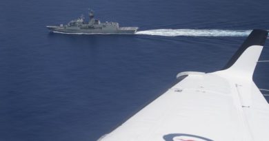 A Royal Australian Air Force KA350 King Air flies past HMAS Anzac in the South China Sea. Photo by Corporal Steve Duncan