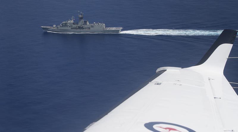 A Royal Australian Air Force KA350 King Air flies past HMAS Anzac in the South China Sea. Photo by Corporal Steve Duncan