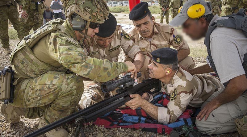 Australian Army soldier Corporal Stefan Pitruzzello makes a scope adjustment on a variant of the Steyr HS .50-calibre rifle while training Iraqi Army personnel in Iraq. Photo by Leading Seaman Jake Badior