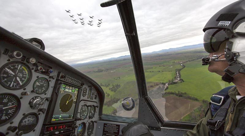 Lieutenant Commander Andrew Kidd, a qualified flying instructor at the ADF Basic Flying Training School, follows a formation of 16 Pacific Aerospace CT-4B Airtrainers flying over Tamworth. Photo by Corporal Ollie Carter