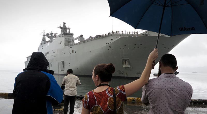 Local media greet HMAS Canberra at the Port of Suva, Fiji. Photo by Commander Ben MacDonald