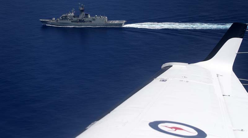 A Royal Australian Air Force KA350 King Air aircraft flies past HMAS Anzac in the South China Sea during Exercise Bersama Shield 16. Photo by Corporal Steve Duncan