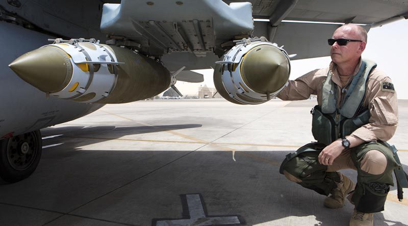 Commander Air Task Group, Air Commodore Philip Gordon, conducts pre-flight checks on an F/A-18A Hornet prior to departing on a mission out of Australia's main air operating base in the Middle East region. This image has been digitally modified. Photo by Corporal Nicci Freeman