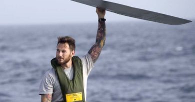 Able Seaman Aviation Technician Aircraft Luke Bacchus spreads the propeller blades of HMAS Perth's embarked MH-60R helicopter.