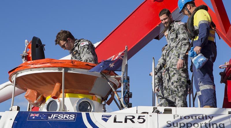 Simulated casualty volunteers enter the LR5 Sub Rescue Vessel to be transferred to HMAS Dechaineux during Ex Black Carillon 2016. Photo by Leading Seaman Bradley Darvill.