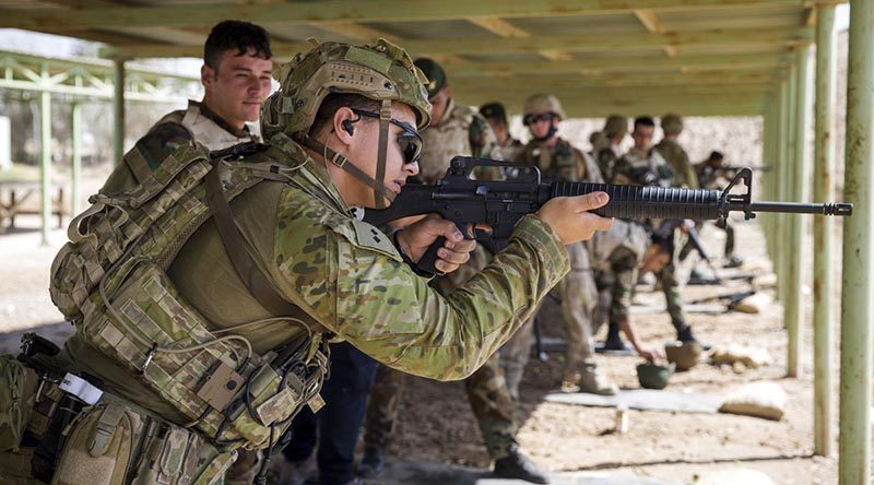 Australian Army officer Lieutenant Curtis Tofa demonstrates marksmanship techniques to an Iraqi Army soldier at Taji Military Complex in Iraq. Photo by Leading Seaman Jake Badior.