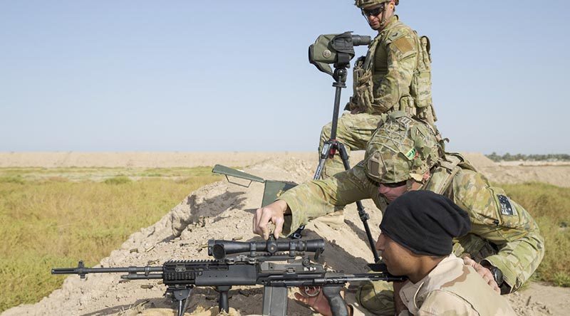 Australian soldier Corporal John Hatch (top) supervises as Private Lyndon Edwards adjusts the sights for an Iraqi Army soldier during marksmanship training at Taji Military Complex near Baghdad, Iraq. Photo by Leading Seaman Jake Badoir.