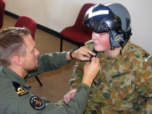 Cadet Corporal Andrew Paxton from 608 (Town of Gawler) Squadron, assisted by Sub Lieutenant Arvids Quinn, prepares for a helicopter flight.