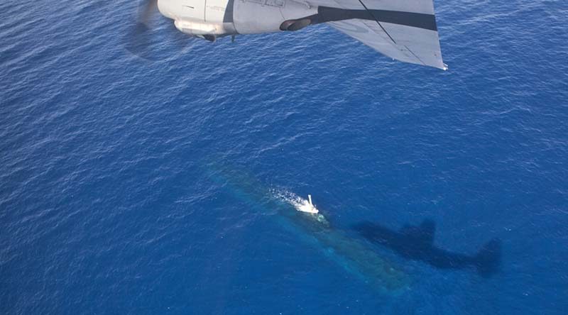 A C-130J Hercules overflies a Royal Australian Navy Collins-class submarine off the WA coast. Photo by Corporal David Gibbs.