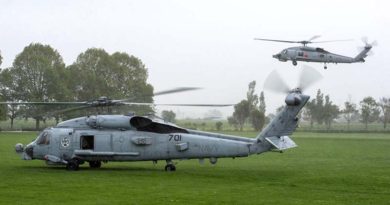 HMAS Darwin's embarked S-70B-2 Seahawk helicopter airborne behind a US Seahawk in Kaikoura, New Zealand. Photo by Corporal Amanda McErlich.