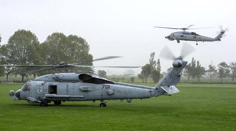 HMAS Darwin's embarked S-70B-2 Seahawk helicopter airborne behind a US Seahawk in Kaikoura, New Zealand. Photo by Corporal Amanda McErlich.