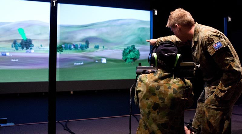 Lieutenant Dustin Gold assists a visitor at the Singleton Army WTSS (Weapon Training Simulation System) complex sight targets for a simulated 66mm anti-armour rocket. Photo by Leading Seaman Brenton Freind.