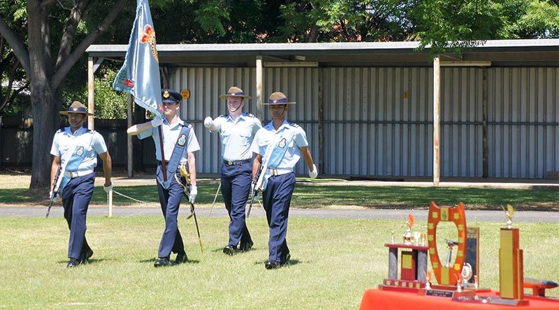 Banner Bearer Cadet Under Officer Hayden Skiparis, with Banner Warrant Officer Cadet Sergeant Joshua Watson and Banner Escorts Cadet Corporal Suyash Jain and Cadet Corporal Michael Santos proudly march on the Banner of No 6 Wing AAFC. Photo by Pilot Officer (AAFC) Paul Rosenzweig.