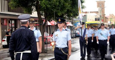 Chief Inspector Alby Quinn, Officer in Charge of the SAPOL Barossa Local Service Area challenges Cadet Under Officer Aaron Musk, while Scroll Bearer, Cadet Corporal Casey Dibben, Banner Escort, Cadet Flight Sergeant Jake Dippy; Banner Bearer, Cadet Under Officer Hayden Skiparis; Banner Warrant Officer Cadet Flight Sergeant Benjamin Kurtz; Banner Escort, Cadet Corporal Andrew Paxton and the rest of 608 Sqn AAFC watch on. Photo by Pilot Officer (AAFC) Paul Rosenzweig.