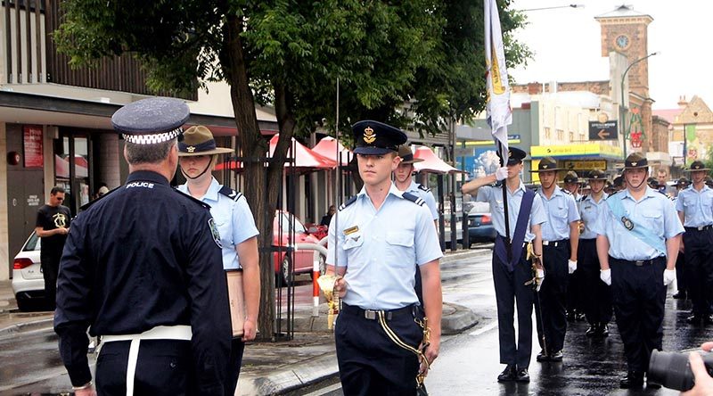 Chief Inspector Alby Quinn, Officer in Charge of the SAPOL Barossa Local Service Area challenges Cadet Under Officer Aaron Musk, while Scroll Bearer, Cadet Corporal Casey Dibben, Banner Escort, Cadet Flight Sergeant Jake Dippy; Banner Bearer, Cadet Under Officer Hayden Skiparis; Banner Warrant Officer Cadet Flight Sergeant Benjamin Kurtz; Banner Escort, Cadet Corporal Andrew Paxton and the rest of 608 Sqn AAFC watch on. Photo by Pilot Officer (AAFC) Paul Rosenzweig.