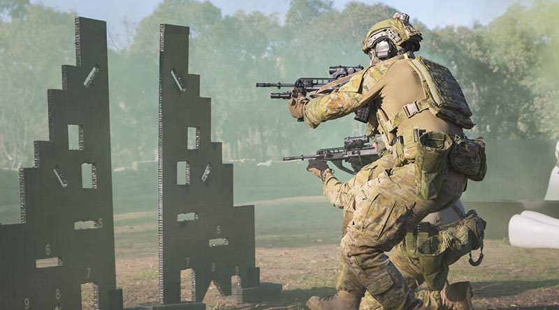 Corporal James Cunningham and Corporal Karl Fabreschi (kneeling) clear the range of 'enemy' activity during the combat shooting skills training activity at Majura training area outside Canberra. Photo by Corporal Nunu Campos.