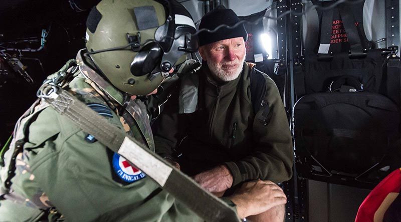 Squadron Leader Rob Visser, an RNZAF doctor, attends to Robin Kane after being lost in New Zealand's Kaimanawa ranges for two nights. RNZDF photo.