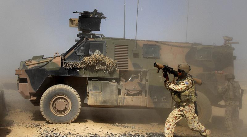 A 1RAR soldier dismounts a Bushmaster equipped with a protected weapon station [or system? – let me know ASAP if I'm wrong] (PWS) to fire the 84mm rocket launcher. Photo by Corporal Jamie Osborne.