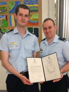 Cadet Sergeant Thomas Stagbouer receives his Certificate of Service from Flying Officer (AAFC) Simon Blair.