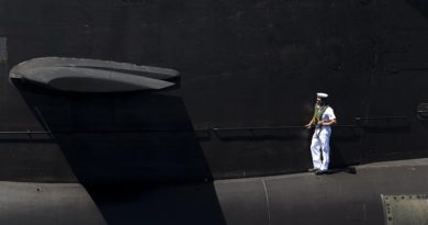 Leading Seaman Leigh Crutchley stands on the casing of HMAS Dechaineux as the boat comes alongside Fleet Base West after completing a busy few months at sea, 17 December 2016. Photo by Leading Seaman Lee-Anne Mack.