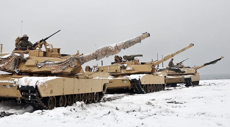 Three M1A2 Main Battle Tanks are staged before soldiers assigned to 1st Battalion, 68th Armor Regiment, 4th Infantry Division conduct the first Live Fire Accuracy Screening Tests at Presidential Range in Swietozow, Poland, January 16, 2017. Photo by Staff Sgt. Elizabeth Tarr