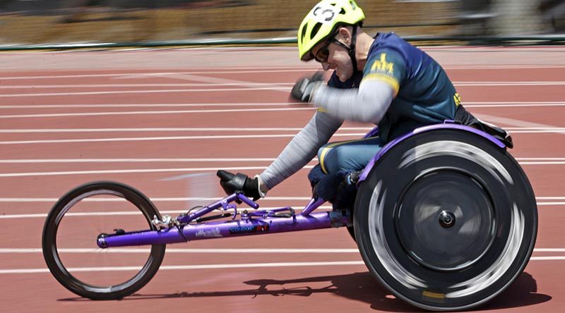 Mark Urquart pumps his fist in triumph as he wins the 400m wheelchair race at the Invictus Games 2016 in Orlando, Florida. Photo by Leading Seaman Jayson Tufrey.