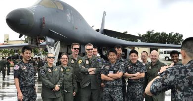 Participants of Exercise Cope North 17 from Japan and Australia pose for a photograph in front of a B-1B Lancer at Andersen Air Force Base. Photo by Sergeant Amanda Campbell.