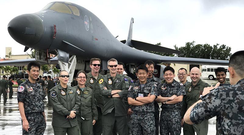 Participants of Exercise Cope North 17 from Japan and Australia pose for a photograph in front of a B-1B Lancer at Andersen Air Force Base. Photo by Sergeant Amanda Campbell.