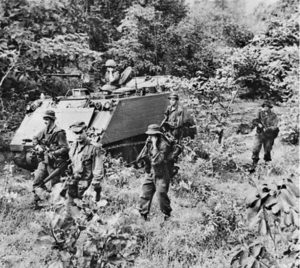 One of thousands of photos taken by Billy Cunneen in Vietnam – 1966, Australian APCs of 1 APC Sqn and dismounted soldiers pursue retreating Viet Cong troops in Phuoc Tuy Province. Click to enlarge.