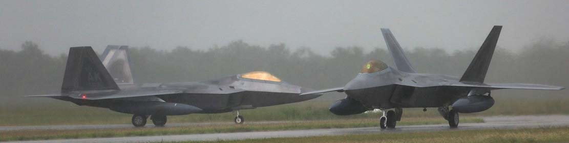 F-22s arrive at RAAF Base Tindal during a monsoonal downpour. Photo by Sergeant Andrew Eddie.