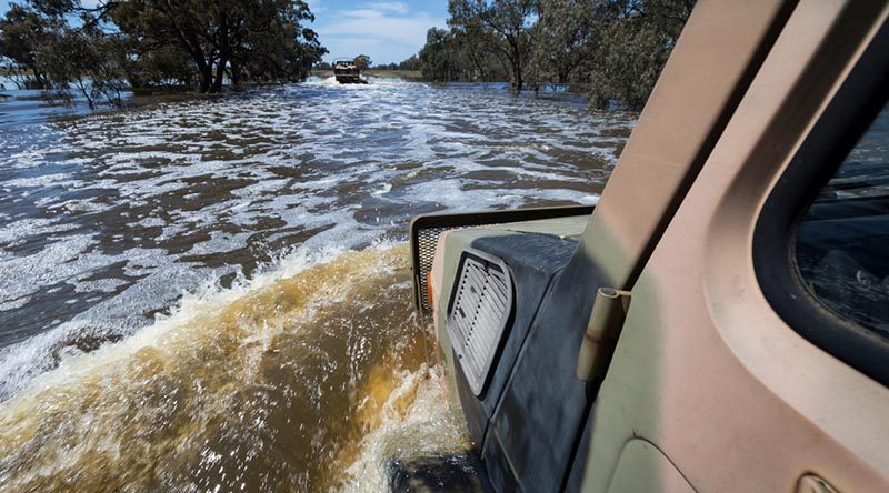 An Australian Army Unimog from 5th Brigade drives through flood waters during a mission to deliver sandbags to a NSW farmer. Photo by Corporal David Said.