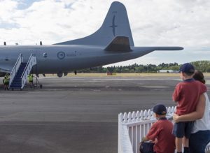Two sad but proud boys see daddy off to war before school at RNZAF Base Whenuapai.