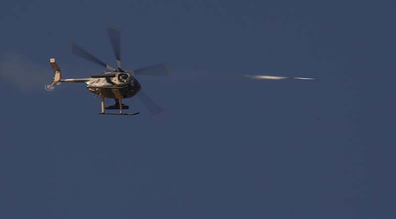 An Afghanistan Air Force Cayuse Warrior helicopter conducts an air-to-ground rocket attack during Afghanistan National Army and Air Force Terminal Air Controllers practical assessment of their training. Photo by Sergeant Rob Hack.