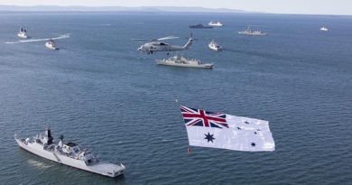 The Australian White Ensign flies over a multi-national fleet of ships at anchor in Jervis Bay. File photo by Able Seaman Sarah Williams.