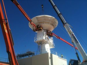 Hoisting and locking the parabolic antenna into place on the joint Australian/United States C-Band Space Surveillance Radar at Exmouth, Western Australia (file photo 2014).