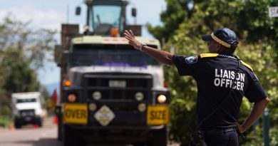A Queensland Police officer directs an Army Mack Truck From 3 Combat Engineering Regiment as it arrives in Bowen, Queensland, in the wake of Tropical Cyclone Debbie. Photo by Corporal David Said.