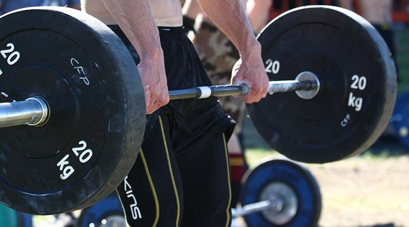 Deadlifting for max reps at a Crossfit comp. Photo by Brian Hartigan.