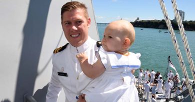 Lieutenant Brock West and his daughter Aria on HMNZS Taupo at Devonport Naval Base.
