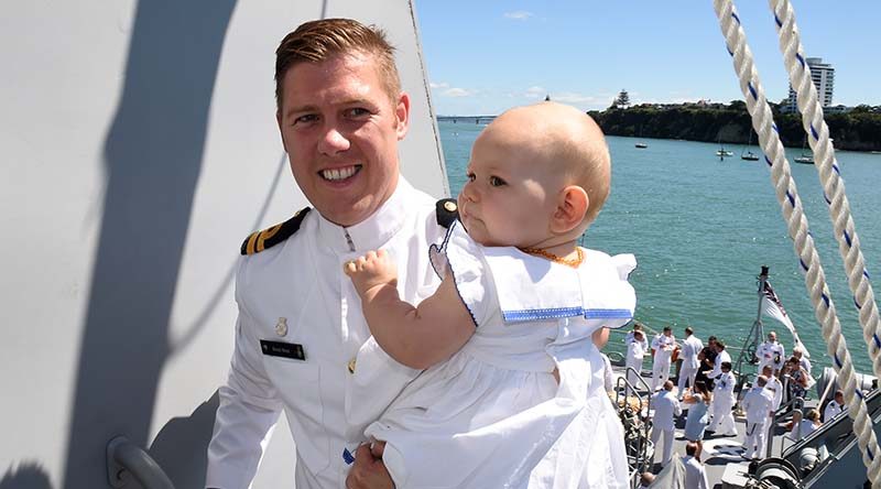 Lieutenant Brock West and his daughter Aria on HMNZS Taupo at Devonport Naval Base.