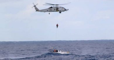 A Royal Australian Navy rescue diver from HMAS Parramatta's Seahwak Helicopter 'Blackjack' prepares to extract the three-man crew from stricken yacht 'Jedi 1'.