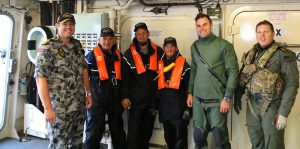 Three happy rough-seas warriors and their rescuers on HMAS Parramatta.