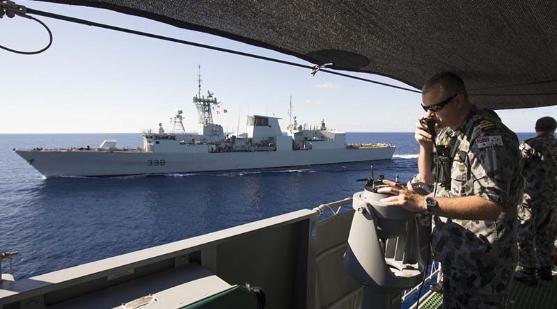 Lieutenant Aaron Norley conning HMAS Ballarat in company with the Royal Canadian Navy ship HMCS Winnipeg conduct Officer of the Watch manoeuvres during HMAS Ballarat's South East Asia Deployment. Photo by Able Seaman Bradley Darvill.