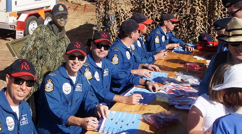 Roulettes pilots autograph posters and give souvenirs to the public attending the 2017 Barossa Air Show, without noticing the photo-bomb by the Air Force Cadets’ “Ghillie Girl”. Photo by Pilot Officer (AAFC) Paul Rosenzweig.