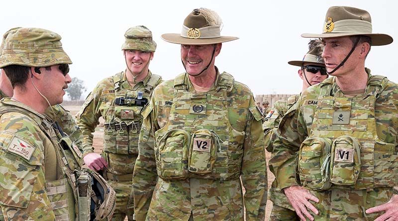 Chief of Army Lieutenant General Angus Campbell (right), and Regimental Sergeant Major-Army Warrant Officer Don Spinks, receive a brief from Sergeant Peter Papalia during a visit to Task Group Taji 4 in Iraq. Photo by Corporal Kyle Jenner.