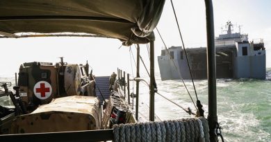 An Australian Army Bushmaster Protected Mobility Vehicle ambulance on an LCM8 landing craft exits the well dock of HMAS Choules. Photo by Able Seaman Bonny Gassner.