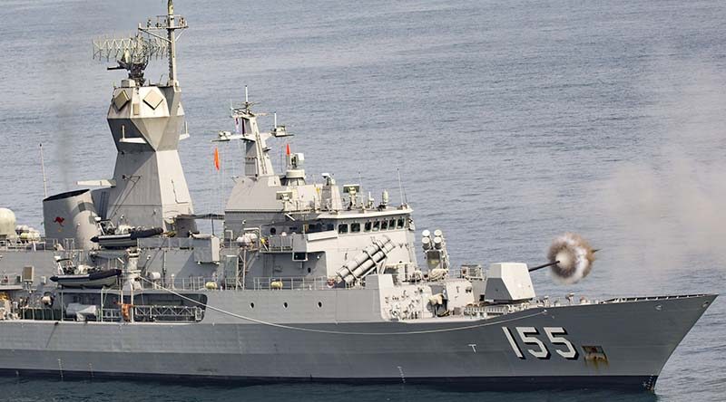 Royal Australian Navy's HMAS Ballarat fires her gun during an exercise with a Chinese ship, near Zhanjiang, China. Photo by Leading Seaman Bradley Darvill.