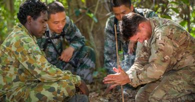 Australian Army soldier Lance Corporal Vinnie Rami (left) guides US Army soldier Sergeant First Class Adam Marques (right) through creating fire using the traditional 'drill' method, while two Chinese soldiers look and learn, during Exercise Kowari 2015 in the Daly River region, Northern Territory, Australia. Photo by Lance Corporal Kyle Jenner.